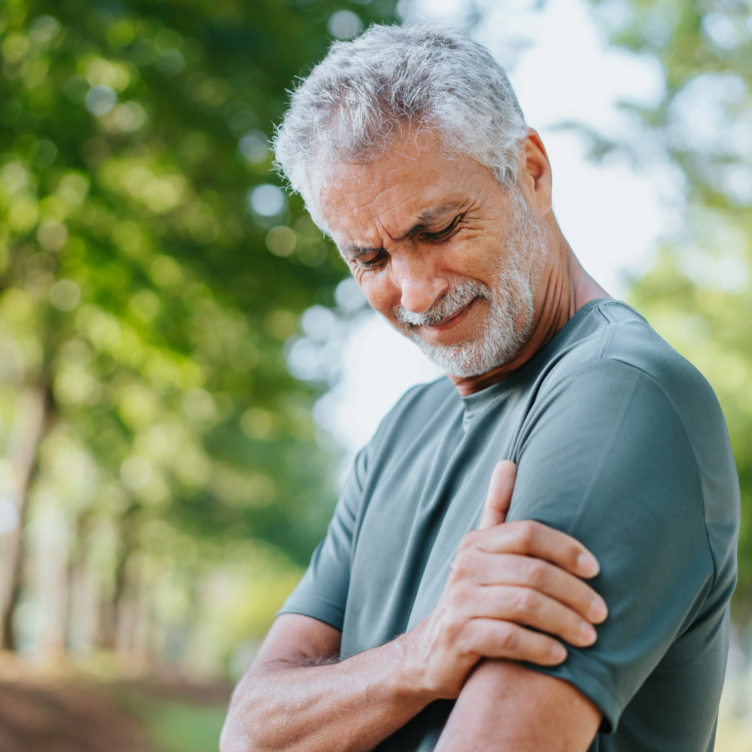 Man with frozen shoulder has difficulty moving his arm