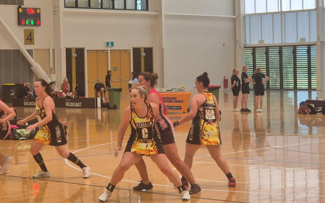 Woman playing netball during a competitive match, demonstrating recreational sport and physical activity