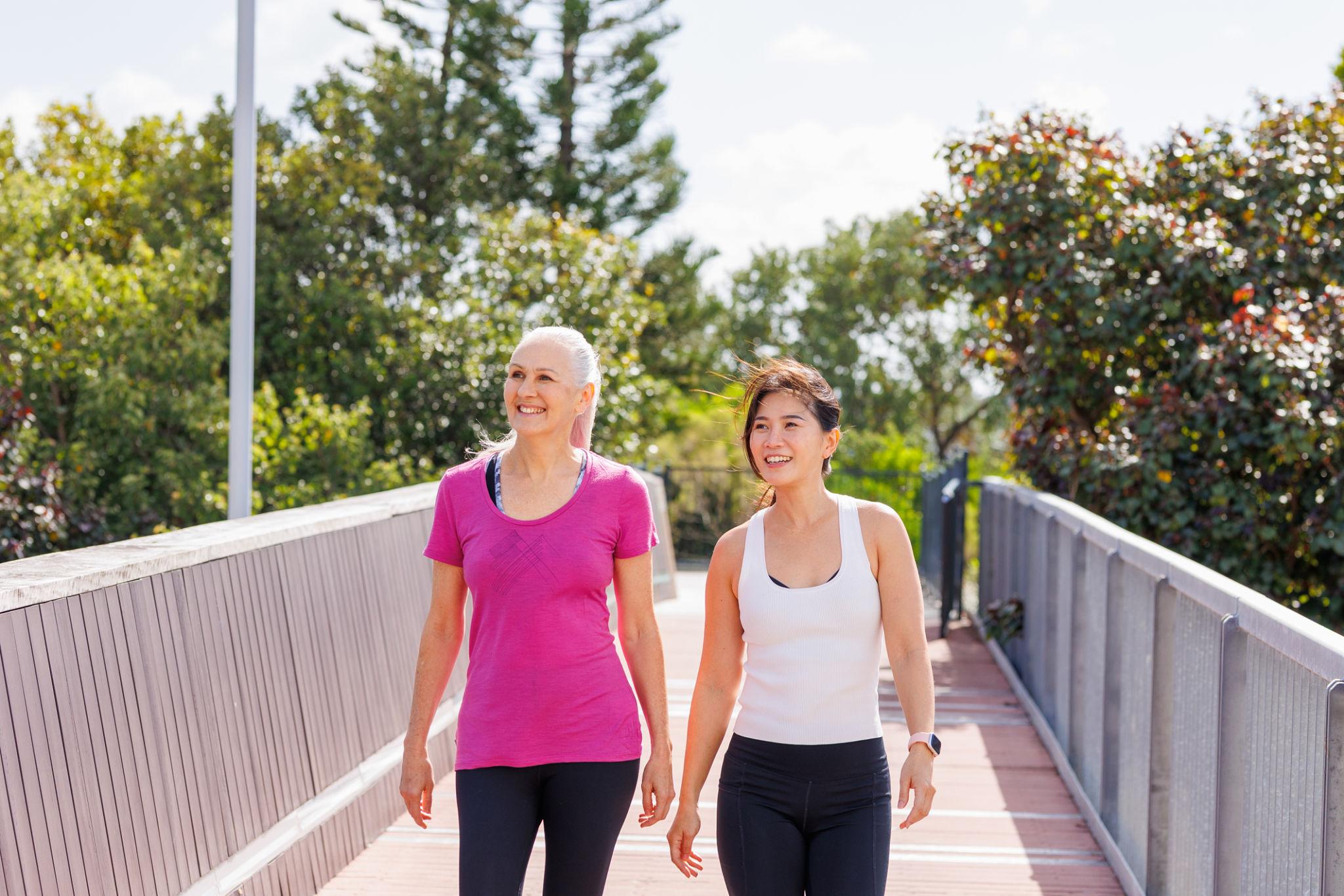 Women walking outdoors, demonstrating how to get back into exercise gradually